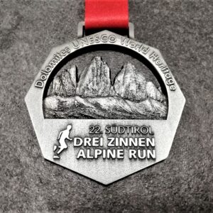 customised Drei Zinnen Alpine Run metal medal in 3D relief with satin gold finish and personalised sublimation ribbon