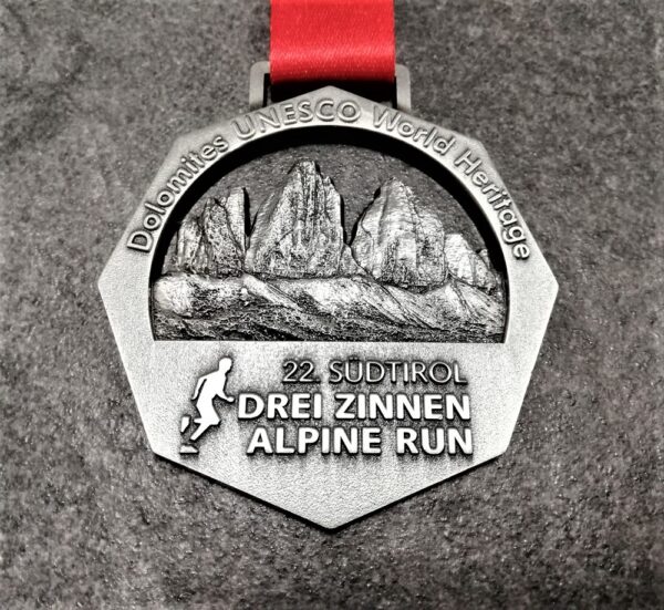 customised Drei Zinnen Alpine Run metal medal in 3D relief with satin gold finish and personalised sublimation ribbon