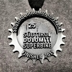 customised Dolomiti Superbike 2019 medal in embossed 2D perforated metal with antique silver finish and personalised silkscreen printed ribbon