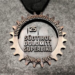 customised Dolomiti Superbike junior 2019 medal in embossed metal 2D perforated antique copper finish with customised silkscreen printed ribbon