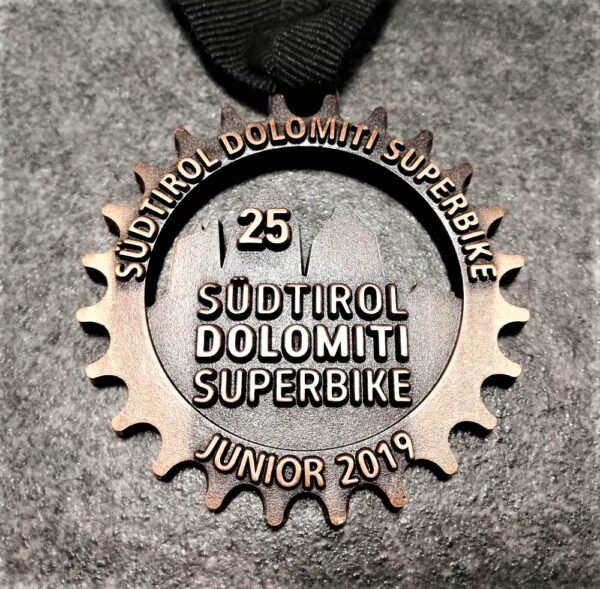 customised Dolomiti Superbike junior 2019 medal in embossed metal 2D perforated antique copper finish with customised silkscreen printed ribbon