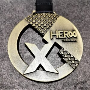 Hero X 2019 customised medal in embossed 2D perforated metal with antique bronze finish and personalised sublimation ribbon