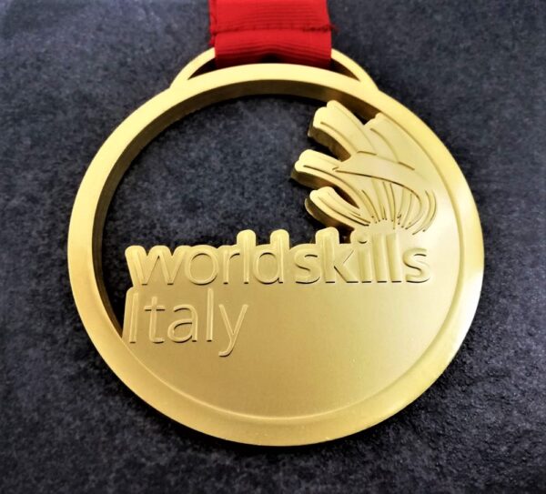 customised World Skills Italy medal in embossed 2D perforated metal with satin gold finish with customised silk-screen printed ribbon