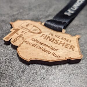 custom caldaro lake half marathon medal natural wood laser cut and engraved with personalized sublimation ribbon side view