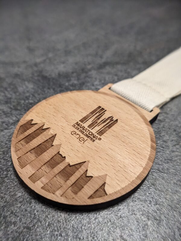 custom dles dolomites marathon medal made of laser-cut and engraved natural wood with recycled cotton ribbon