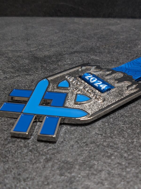 custom marcialonga medal in 2D embossed metal with polished and satin silver finish enamels with personalized sublimation ribbon side view