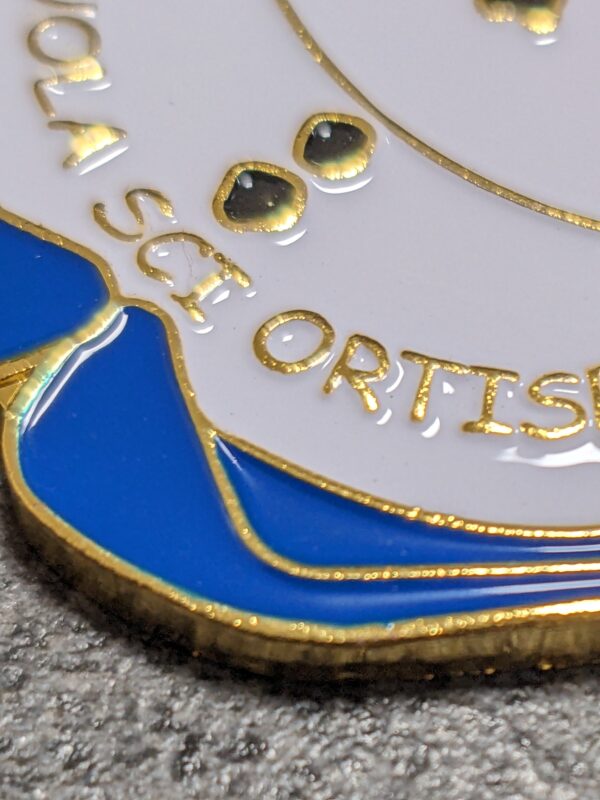 custom ortisei ski school medal in 2D embossed metal with gold finish enamel with personalized sublimation ribbon detail view
