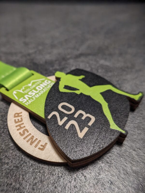 custom saslong half marathon medal made of natural wood laser cut and uv printed with stacked layers with personalized sublimation ribbon side view