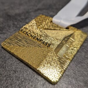 custom skischool reschenpass medal 3D gold finish embossed metal with personalized sublimation ribbon side view