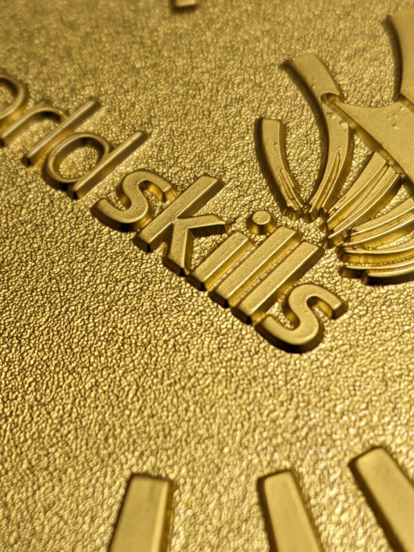 custom worldskills medal embossed metal 2D gold satin finish detail view